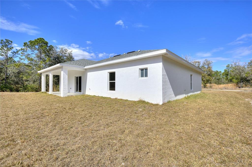 3121 Gardenia Drive Indian Lake Estates, FL 33855 - Photo 24 of 55 a view of a house with a backyard space
