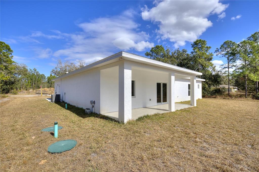 3121 Gardenia Drive Indian Lake Estates, FL 33855 - Photo 27 of 55 a backyard of a house with table and chairs