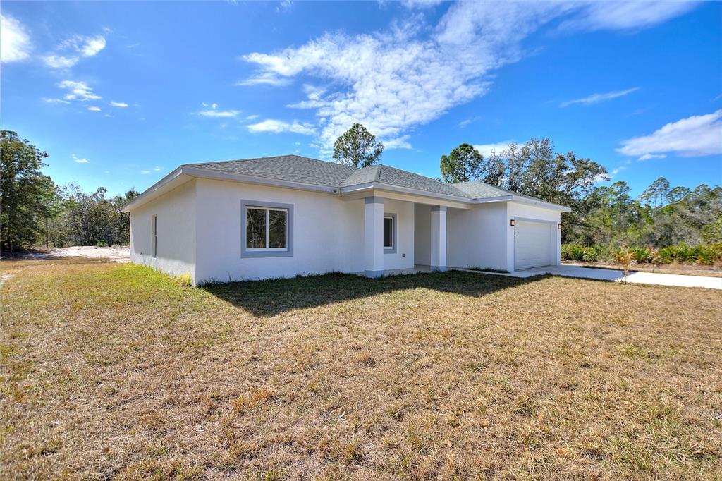 3121 Gardenia Drive Indian Lake Estates, FL 33855 - Photo 28 of 55 a view of a house with a yard