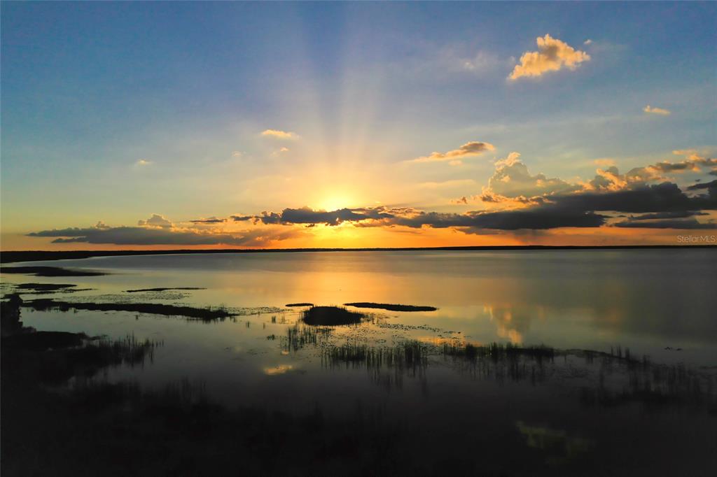 3121 Gardenia Drive Indian Lake Estates, FL 33855 - Photo 37 of 55 a sunset view with a lake