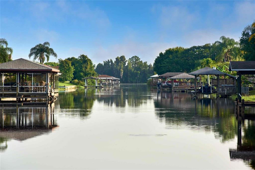 3121 Gardenia Drive Indian Lake Estates, FL 33855 - Photo 42 of 55 a view of a lake with a house in the background