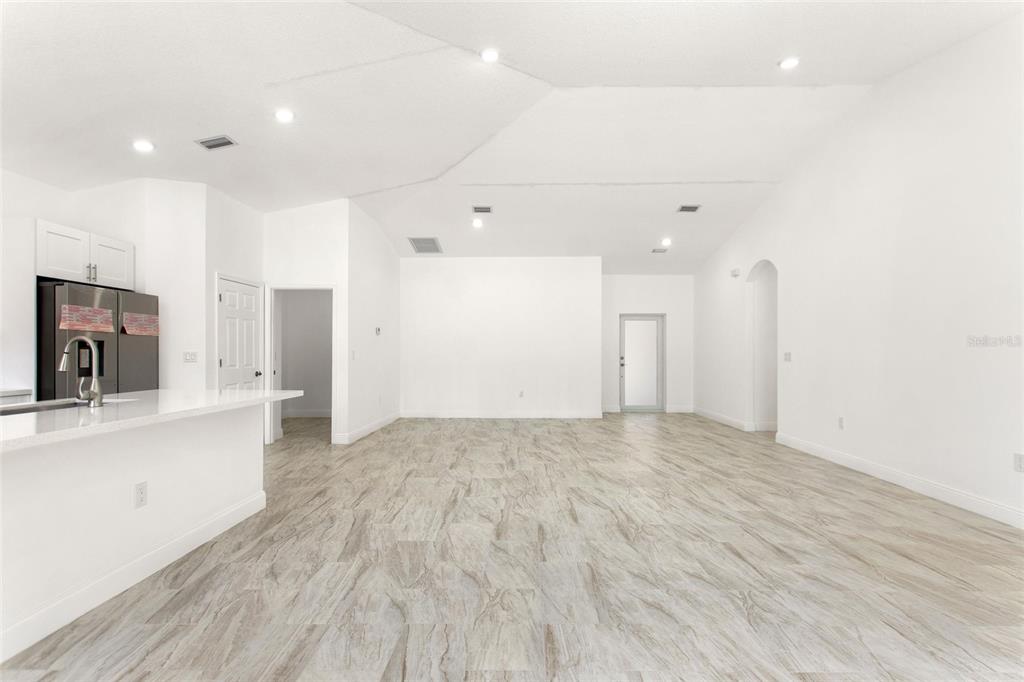 3121 Gardenia Drive Indian Lake Estates, FL 33855 - Photo 6 of 55 a view of empty room with wooden floor and a fireplace
