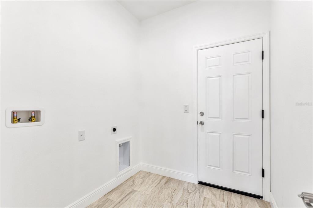 3121 Gardenia Drive Indian Lake Estates, FL 33855 - Photo 9 of 55 a view of a hallway with wooden floor