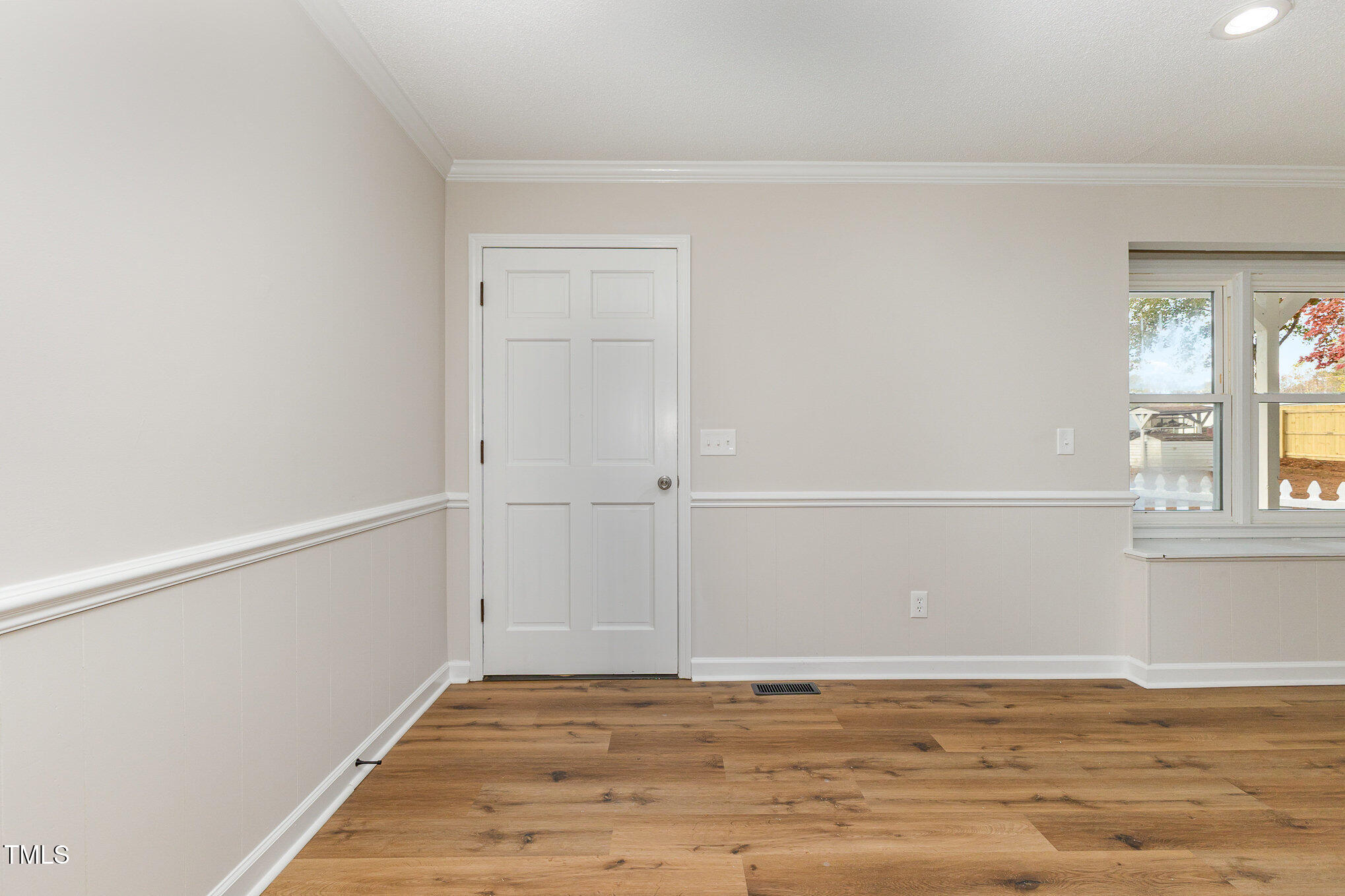 1046 Lipscomb Road Angier, NC 27501 - Photo 6 of 35 a view of an empty room with window and wooden floor
