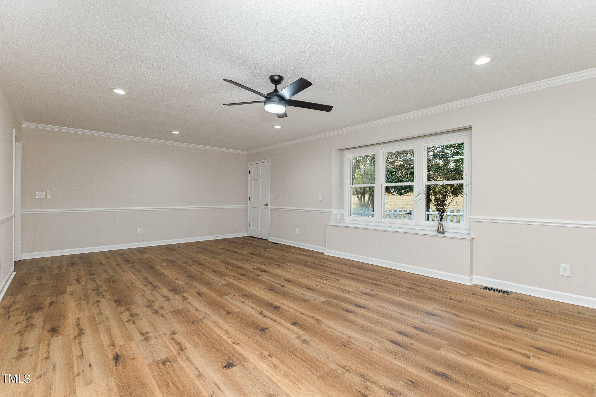 1046 Lipscomb Road Angier, NC 27501 - Photo 8 of 35 a view of an empty room with a window and wooden floor