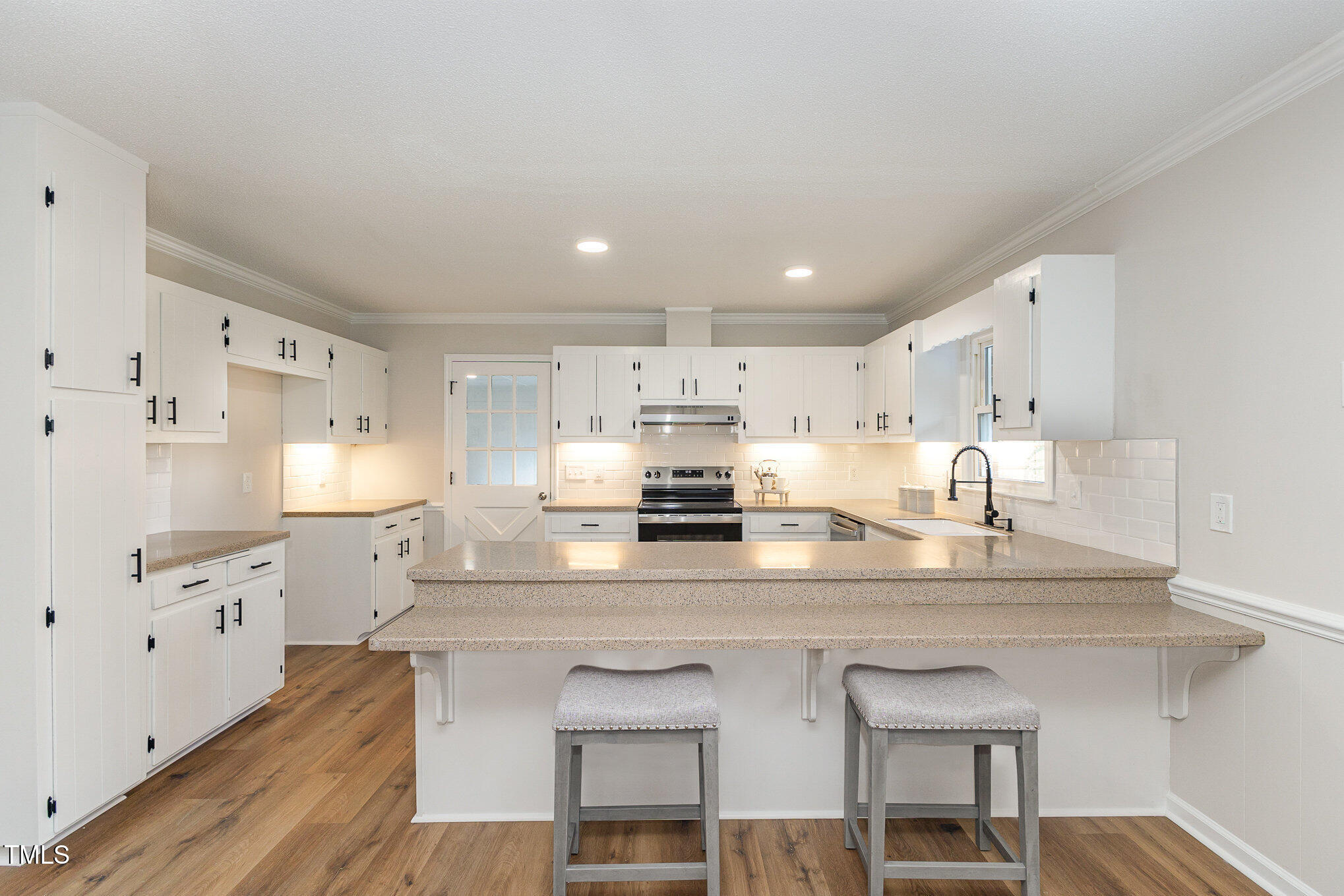 1046 Lipscomb Road Angier, NC 27501 - Photo 9 of 35 a kitchen with kitchen island a counter top space appliances and cabinets