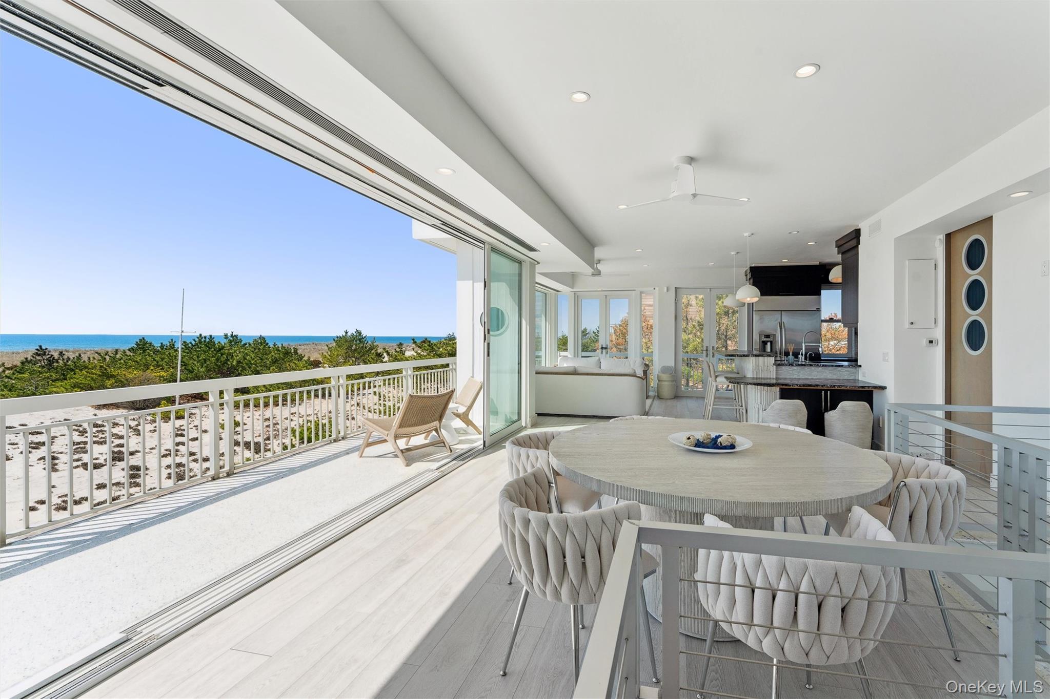 413 B Dune Road Westhampton Beach, NY 11978 - Photo 12 of 26 a view of a dining table and chairs in the balcony