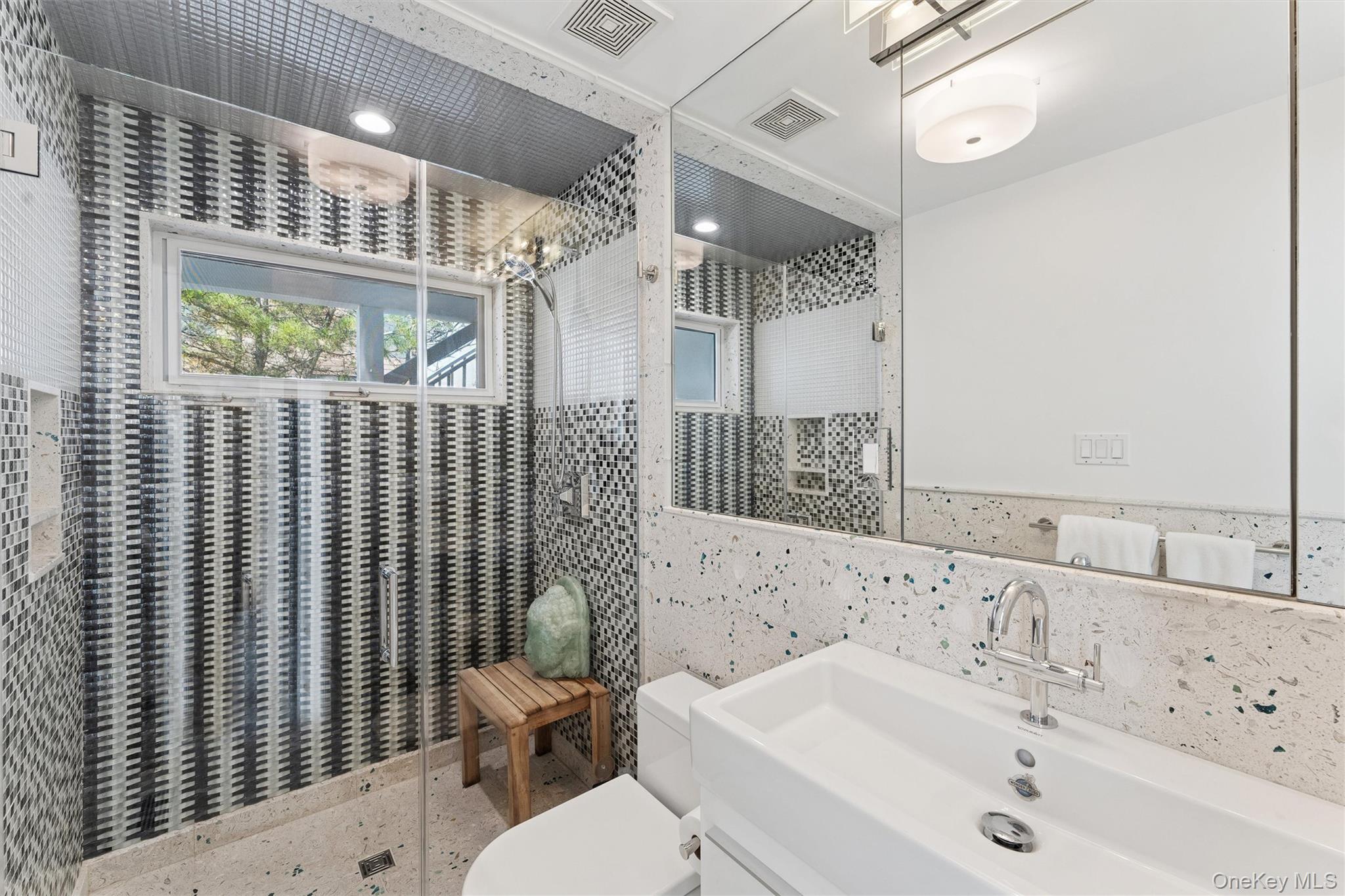 413 B Dune Road Westhampton Beach, NY 11978 - Photo 22 of 26 a bathroom with a sink a toilet and shower