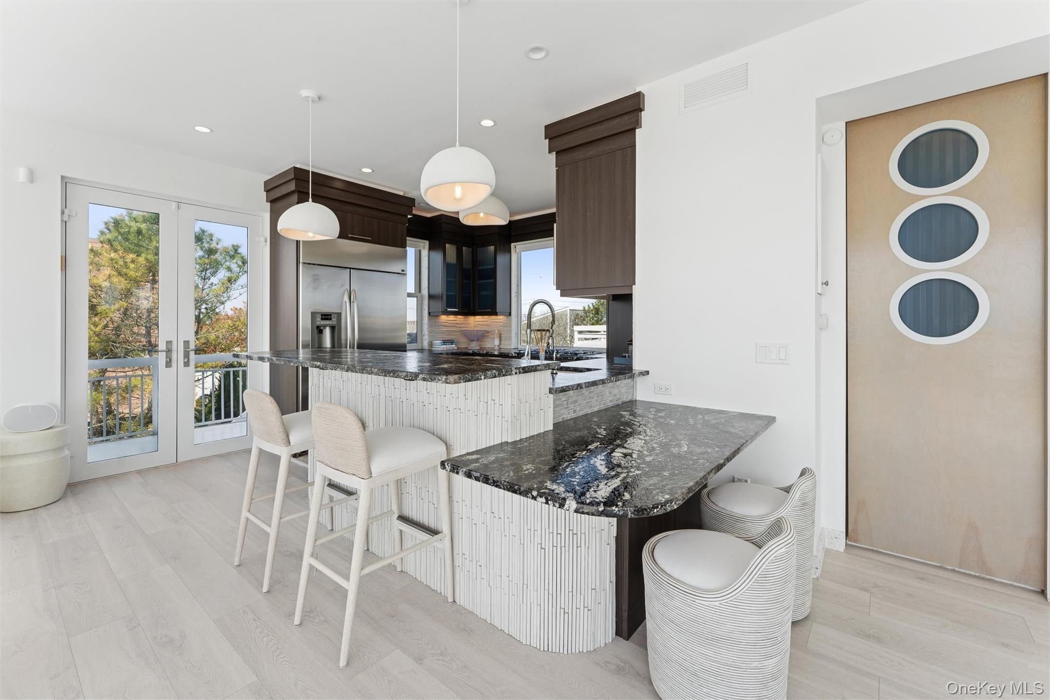 413 B Dune Road Westhampton Beach, NY 11978 - Photo 6 of 26 a kitchen with a dining table and chairs