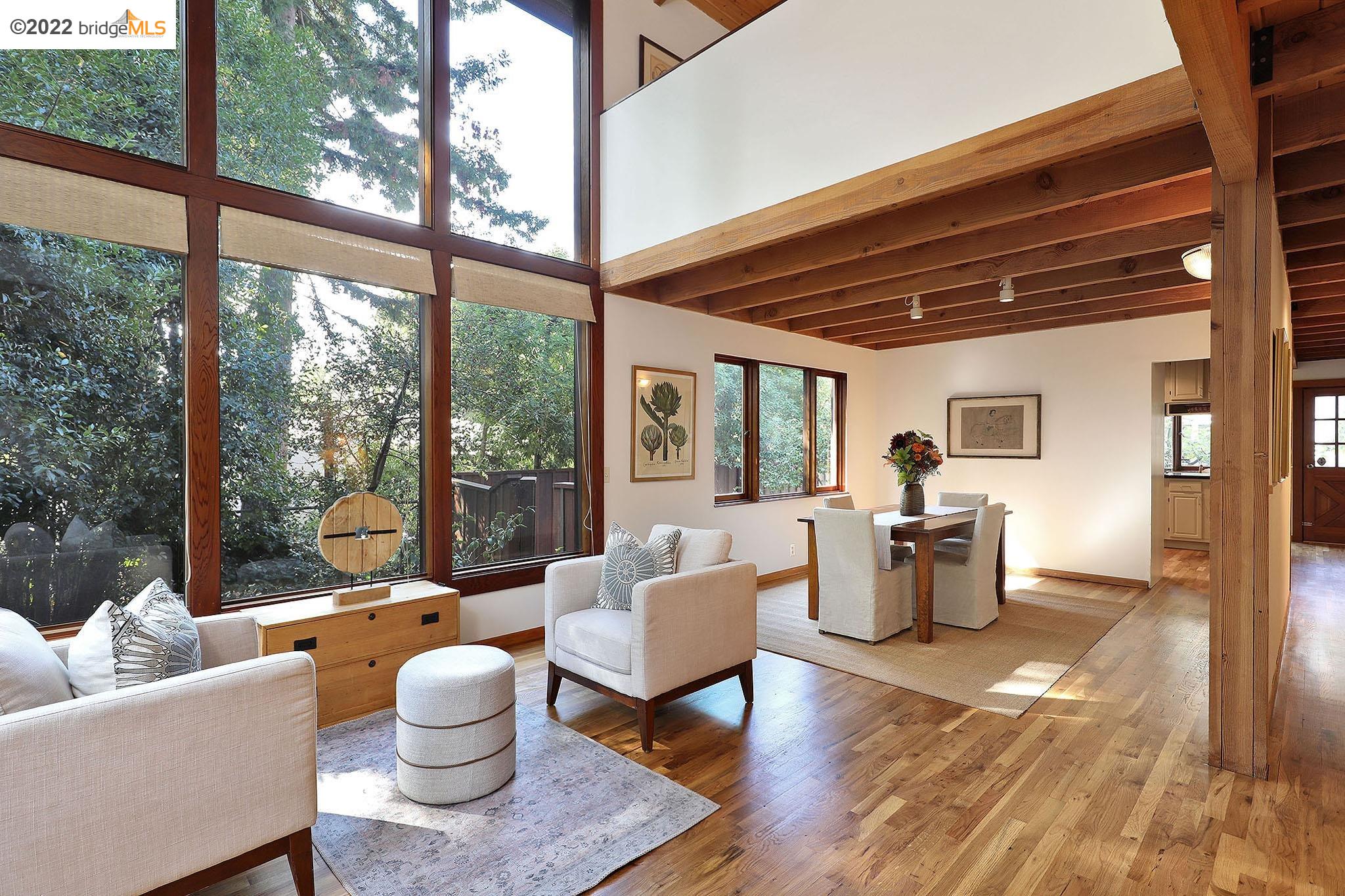 152 Tunnel Road Berkeley, CA 94705 - Photo 1 of 1 a living room with furniture and a large window
