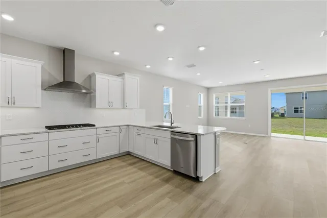 a large kitchen with stainless steel appliances granite countertop a stove and a sink