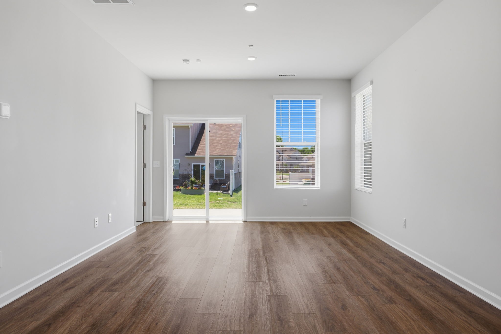 473 Alcott Way Spring Hill Spring Hill, TN 37174 - Photo 8 of 24 a view of an empty room with wooden floor and a window