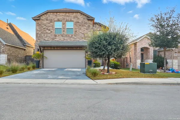 a view of a house with a yard and garage