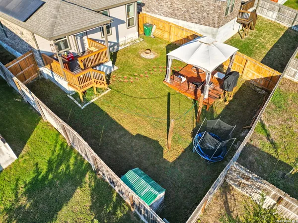 an aerial view of a house with backyard