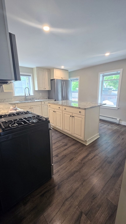 15 Central Street, Unit 4 Georgetown, MA 01833 - Photo 3 of 24 a kitchen with wooden floors and a sink