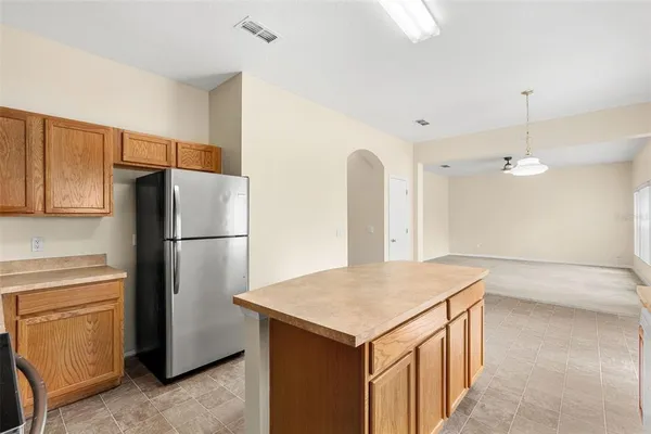 a view of an empty room with window and cabinet