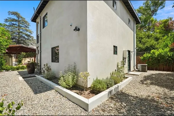 a view of a backyard with potted plants