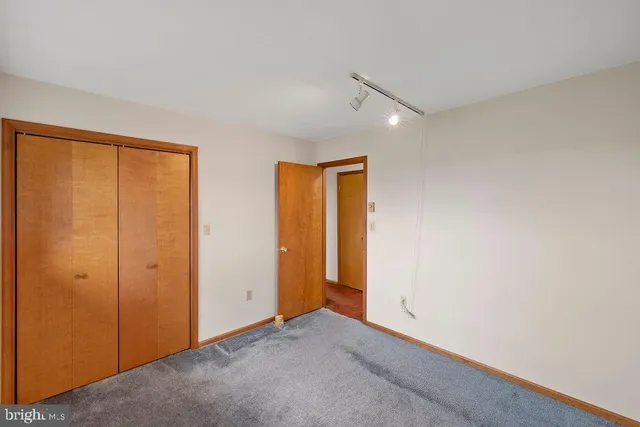 an empty room with closet area