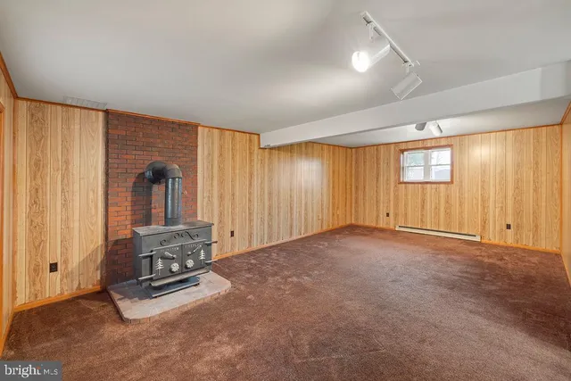an empty room with fireplace and windows