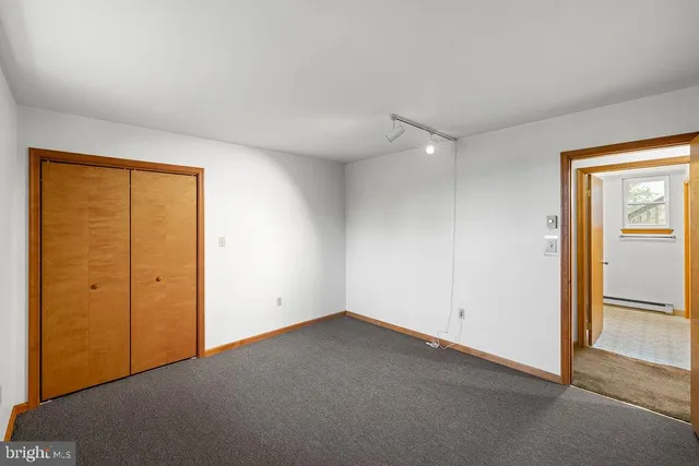 an empty room with closet area