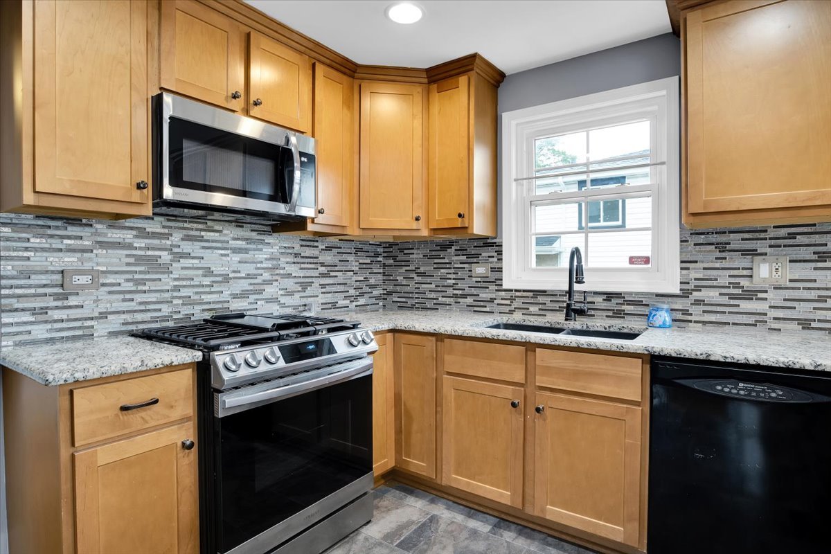10822 Major Avenue Chicago Ridge, IL 60415 - Photo 20 of 30 a kitchen with granite countertop a sink cabinets and stainless steel appliances