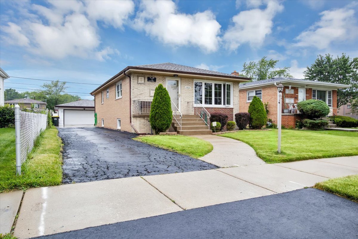 10822 Major Avenue Chicago Ridge, IL 60415 - Photo 2 of 30 a front view of a house with a yard and garage