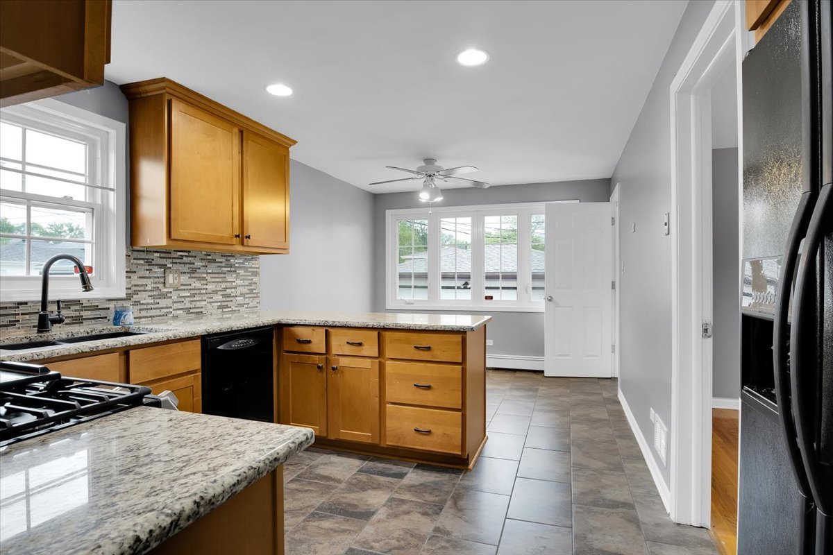 10822 Major Avenue Chicago Ridge, IL 60415 - Photo 21 of 30 a kitchen with a stove a sink and a refrigerator