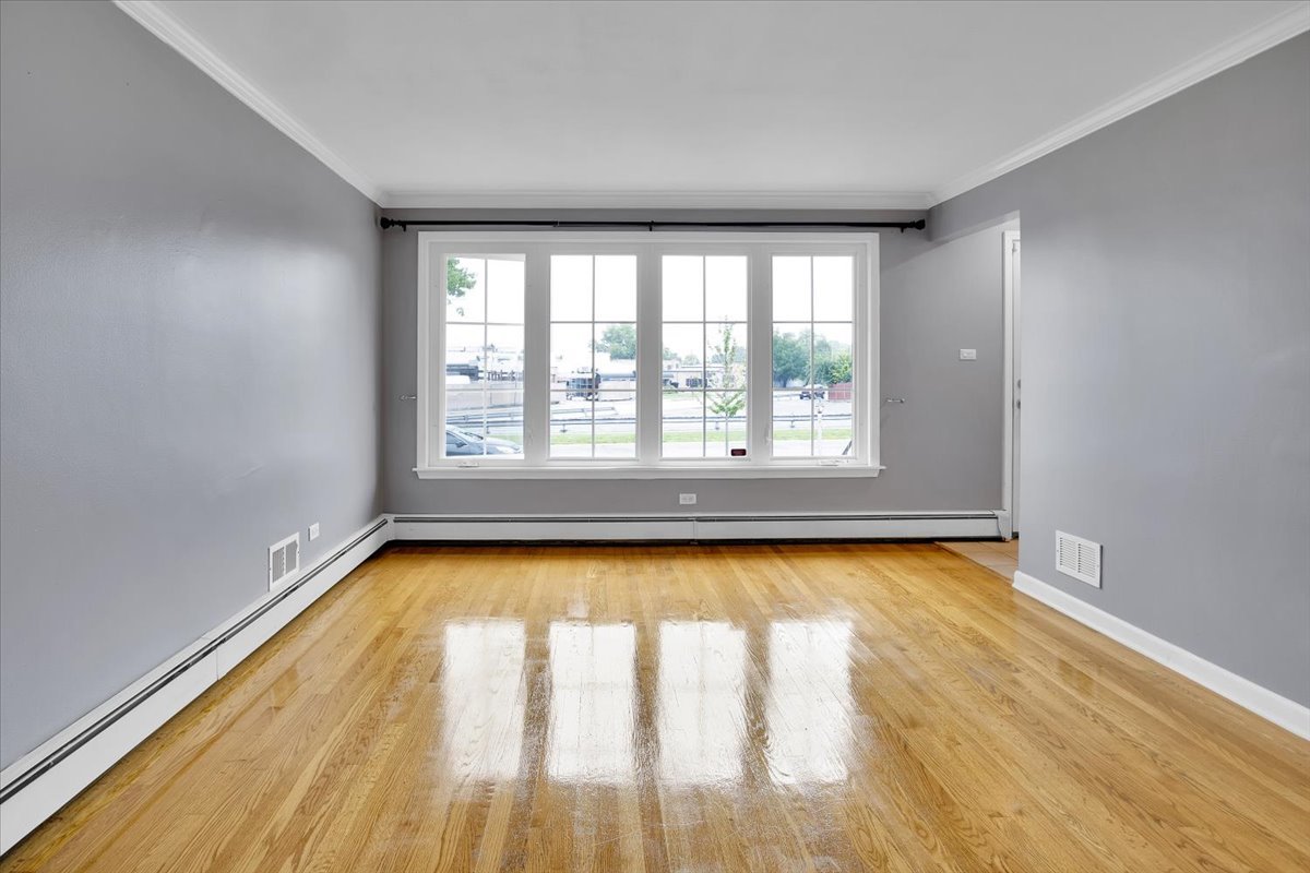 10822 Major Avenue Chicago Ridge, IL 60415 - Photo 9 of 30 a view of an empty room with window and wooden floor