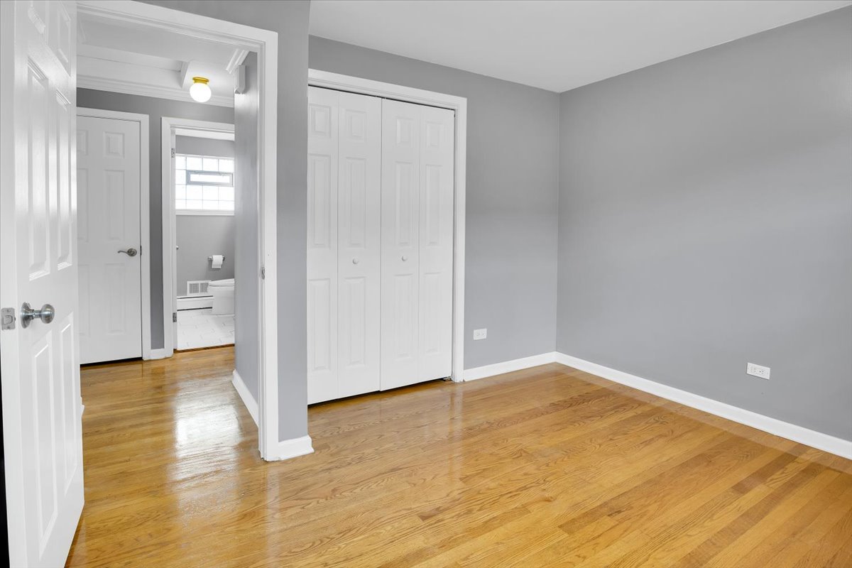 10822 Major Avenue Chicago Ridge, IL 60415 - Photo 10 of 30 a view of an empty room with wooden floor and a bathroom