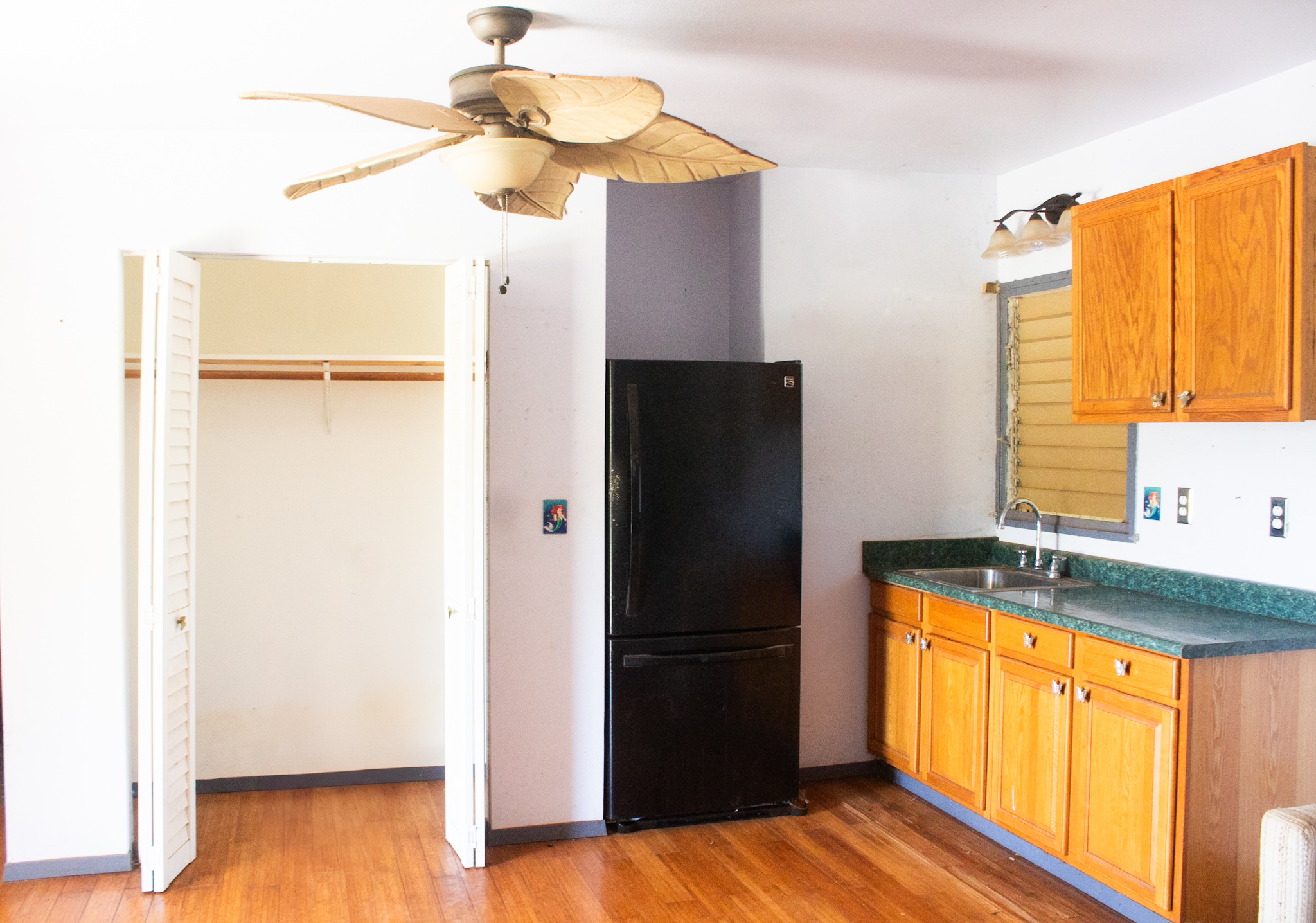 2501 Waipuna Road Lihue, HI 96766 - Photo 12 of 28 a kitchen with a refrigerator and a wooden floor