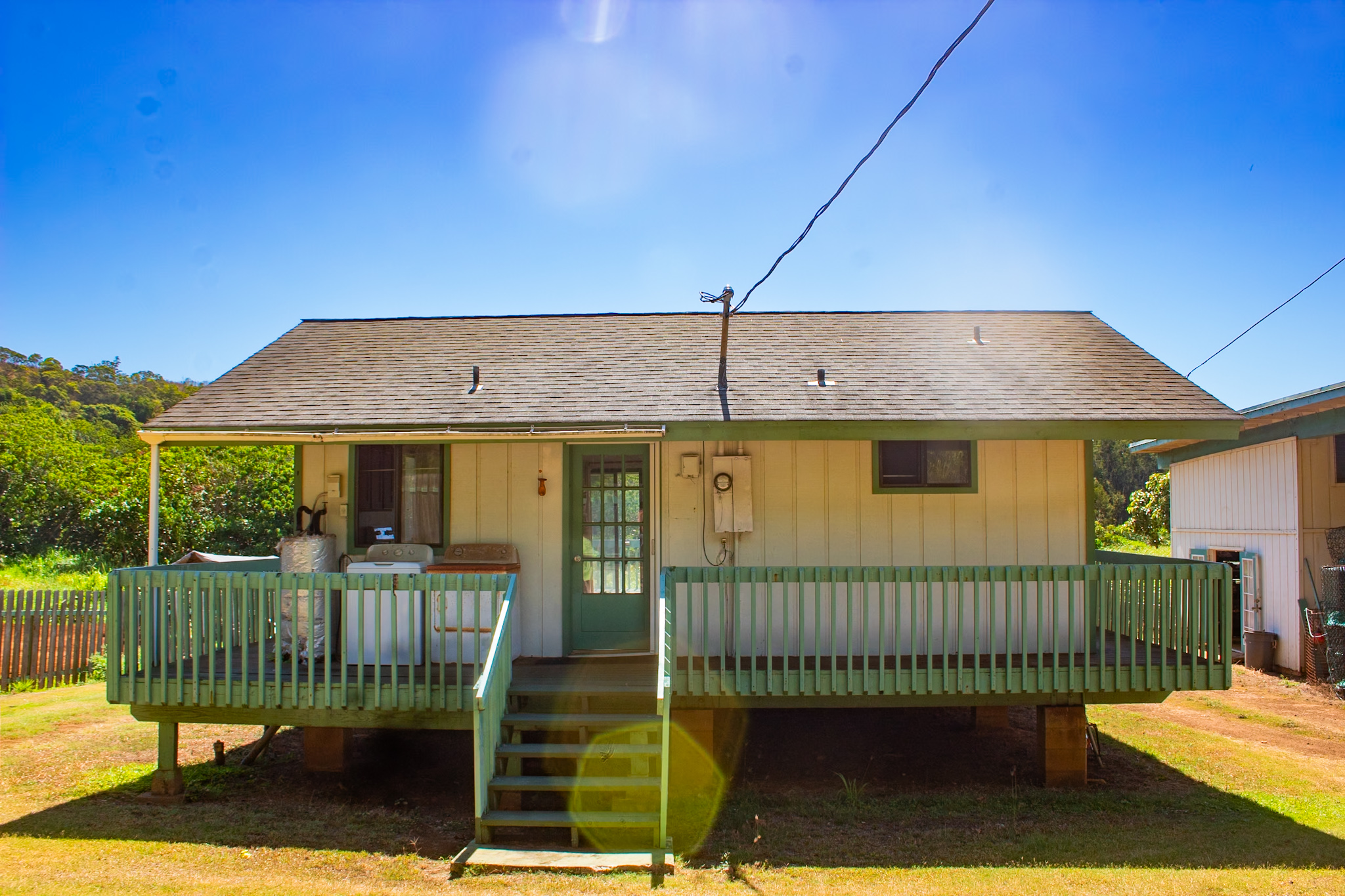 2501 Waipuna Road Lihue, HI 96766 - Photo 2 of 28 a view of a house with a small yard and wooden fence