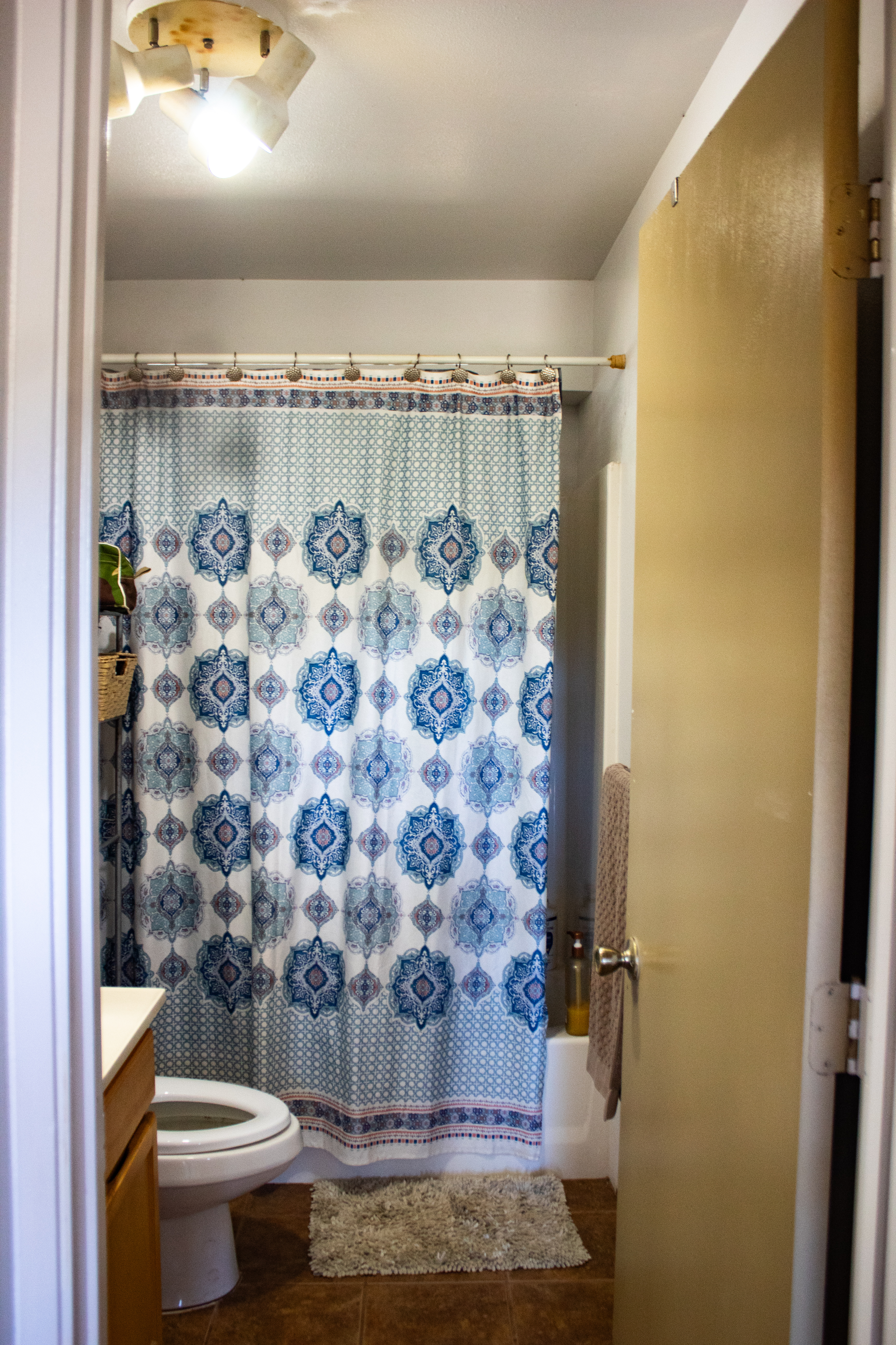 2501 Waipuna Road Lihue, HI 96766 - Photo 22 of 28 a bathroom with a toilet and a shower curtain