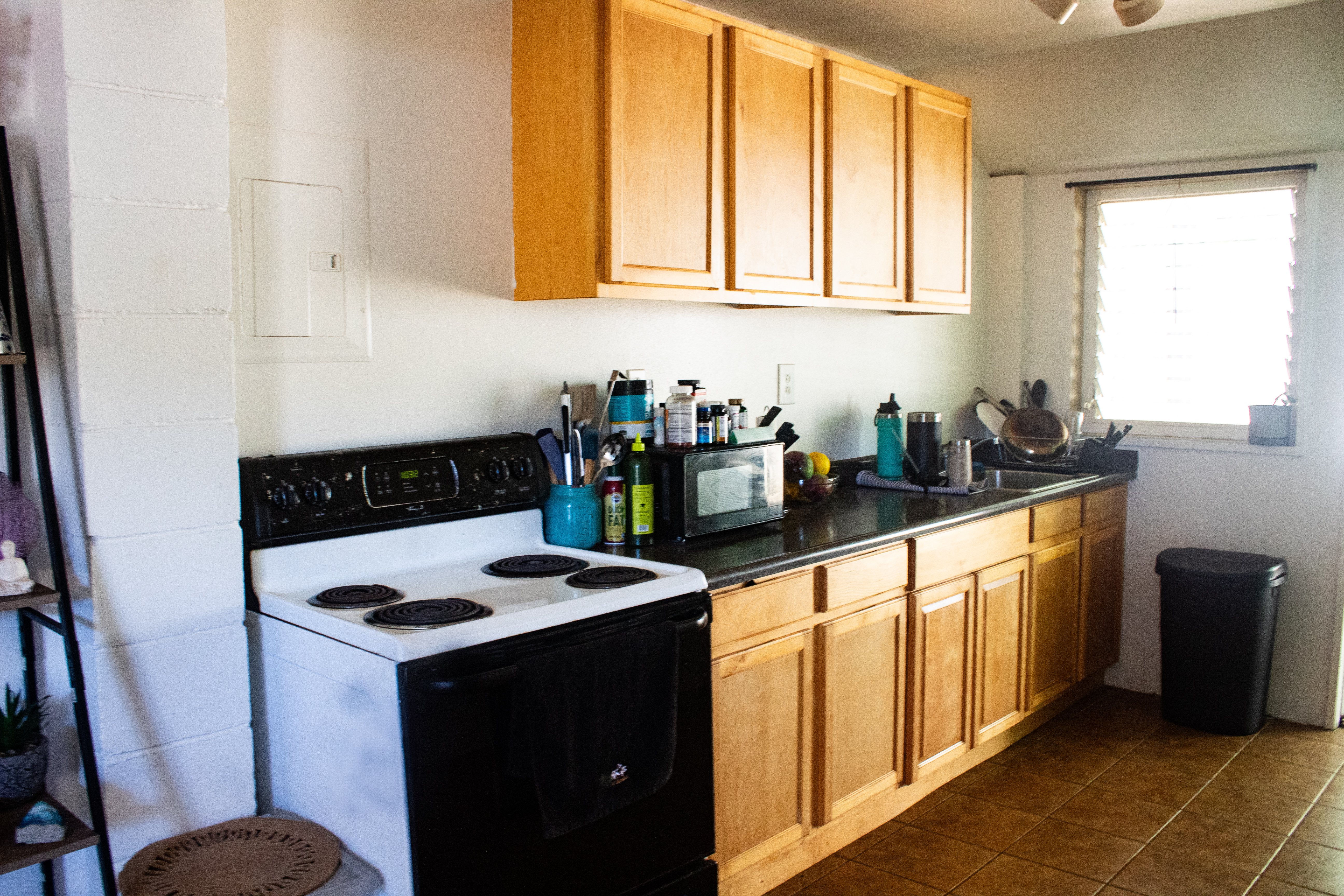 2501 Waipuna Road Lihue, HI 96766 - Photo 24 of 28 a kitchen with stainless steel appliances granite countertop a stove a sink and a microwave