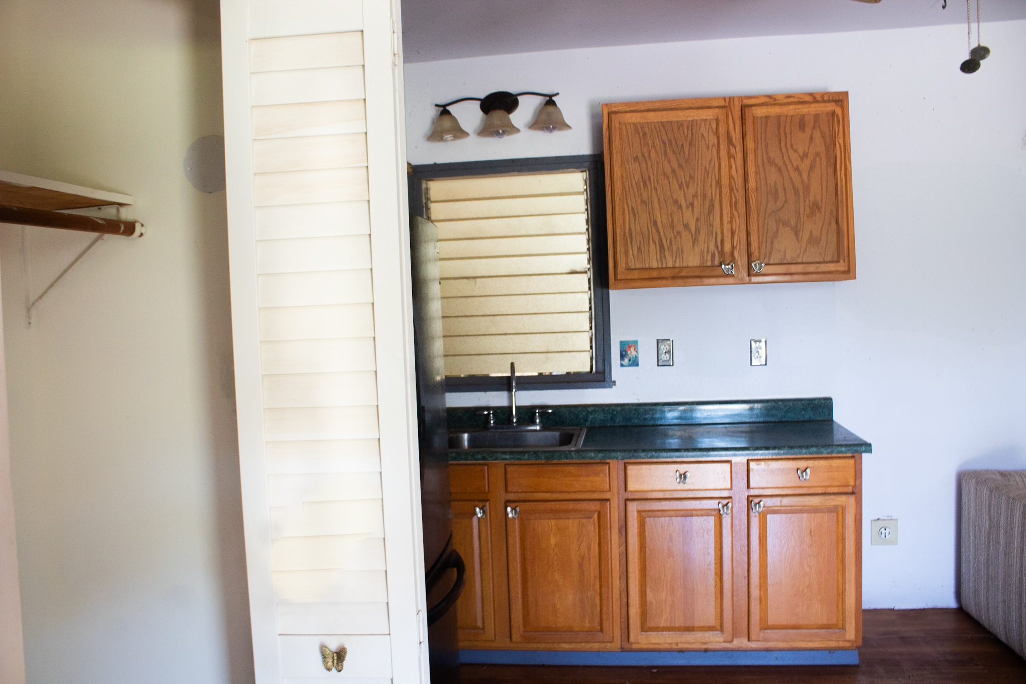 2501 Waipuna Road Lihue, HI 96766 - Photo 28 of 28 a kitchen with granite countertop white cabinets and sink
