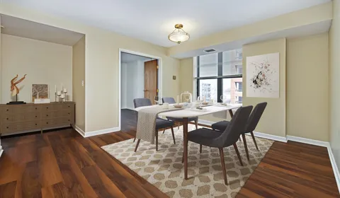 a view of a dining room with furniture and wooden floor
