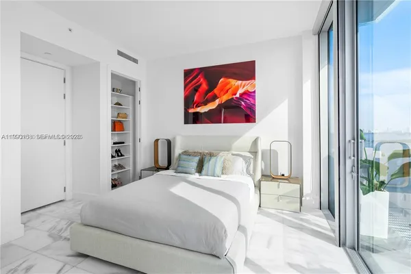 a bedroom with bed and a window