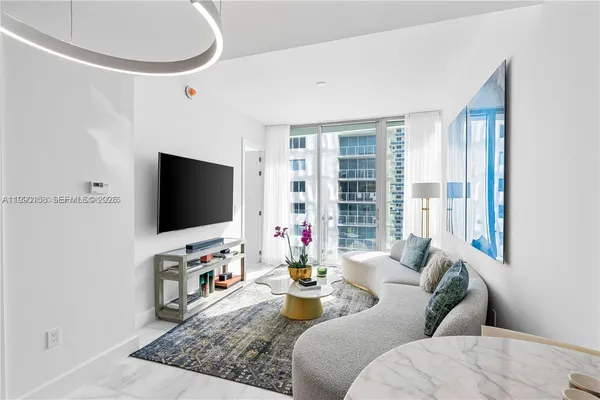 a living room with furniture and a flat screen tv