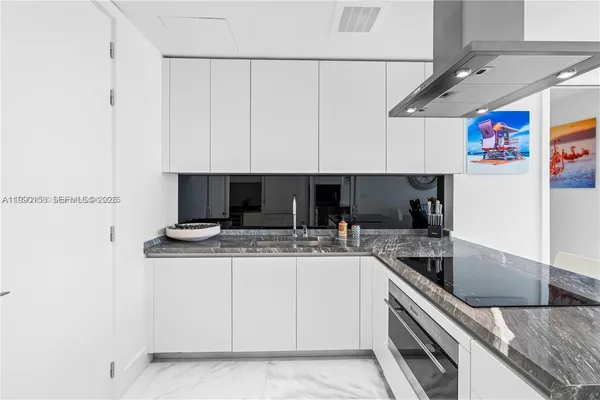 a kitchen with granite countertop a cabinets and a stove