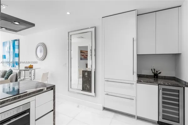 a kitchen with a refrigerator and cabinets