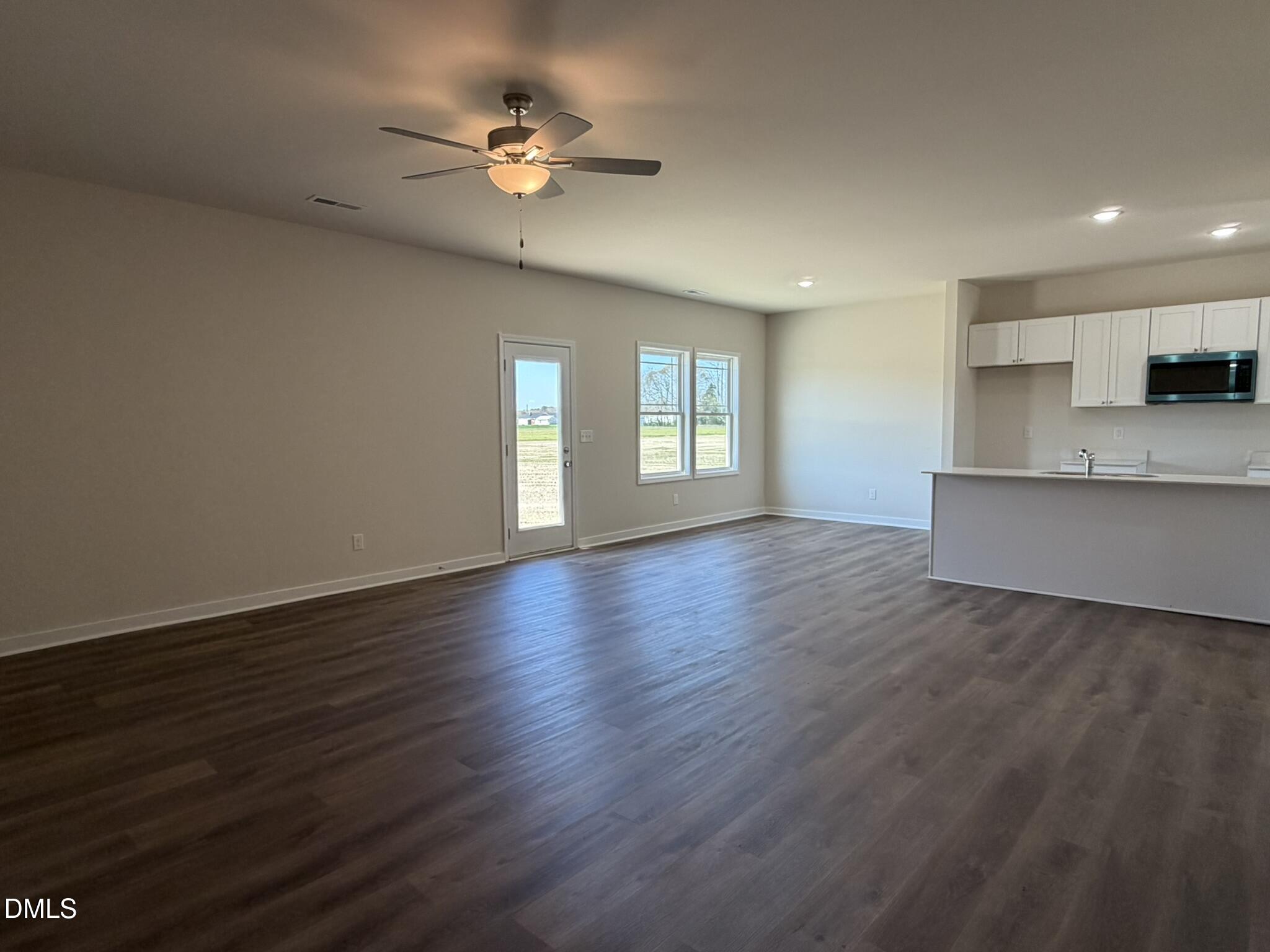 159 Jacobs Ridge Drive Four Oaks, NC 27524 - Photo 9 of 18 a view of an empty room with a window and wooden floor