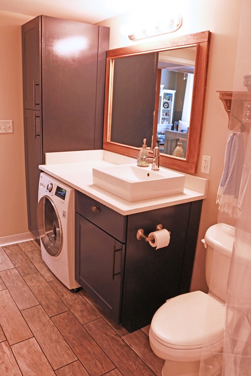 60 Dudley Street, Unit 222 Chelsea, MA 02150 - Photo 9 of 20 a bathroom with a sink a toilet and mirror