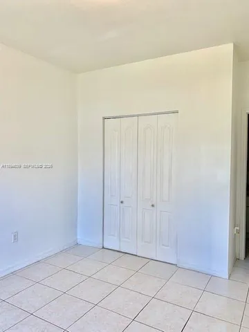 a bathroom with a granite countertop sink mirror and toilet