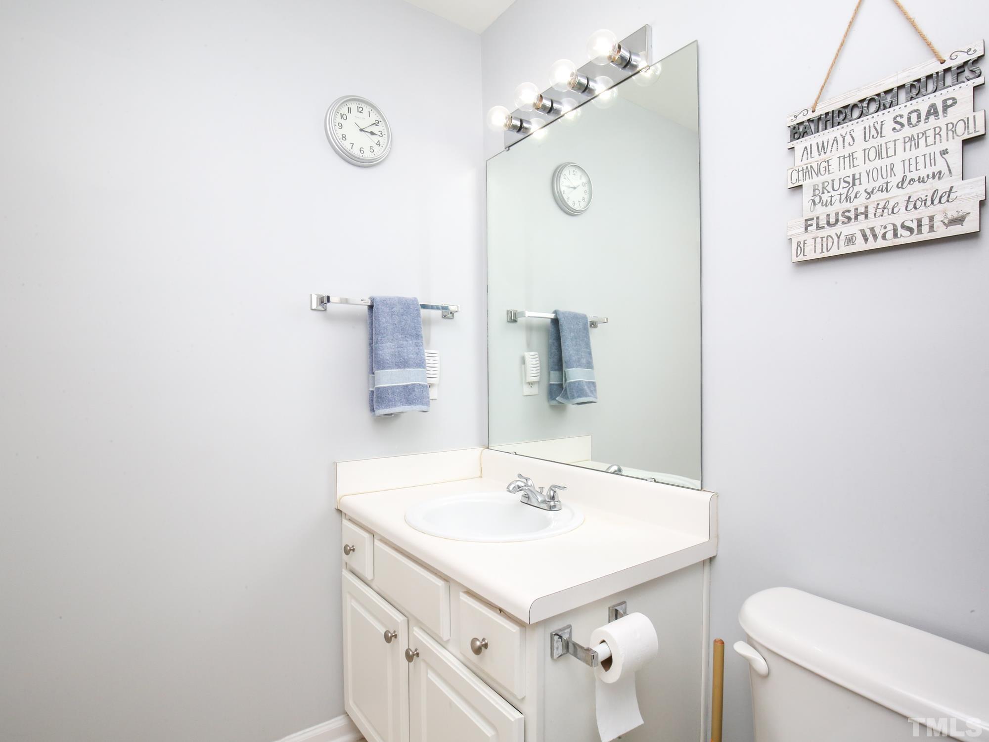 1714 Sorrell Brook Way Raleigh, NC 27609 - Photo 23 of 29 a bathroom with a sink a toilet and a mirror