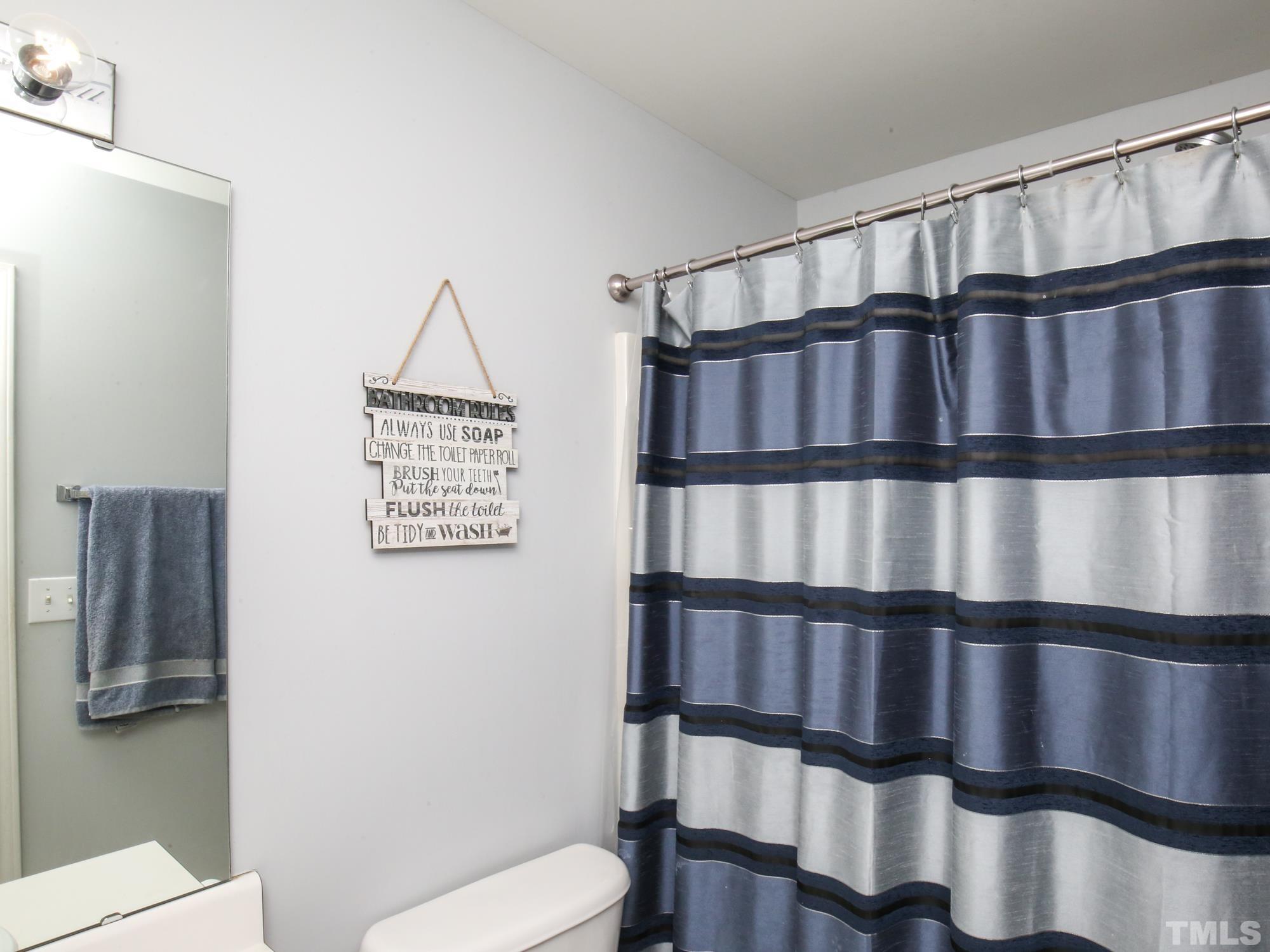 1714 Sorrell Brook Way Raleigh, NC 27609 - Photo 24 of 29 a view of a hallway with wooden floor and staircase