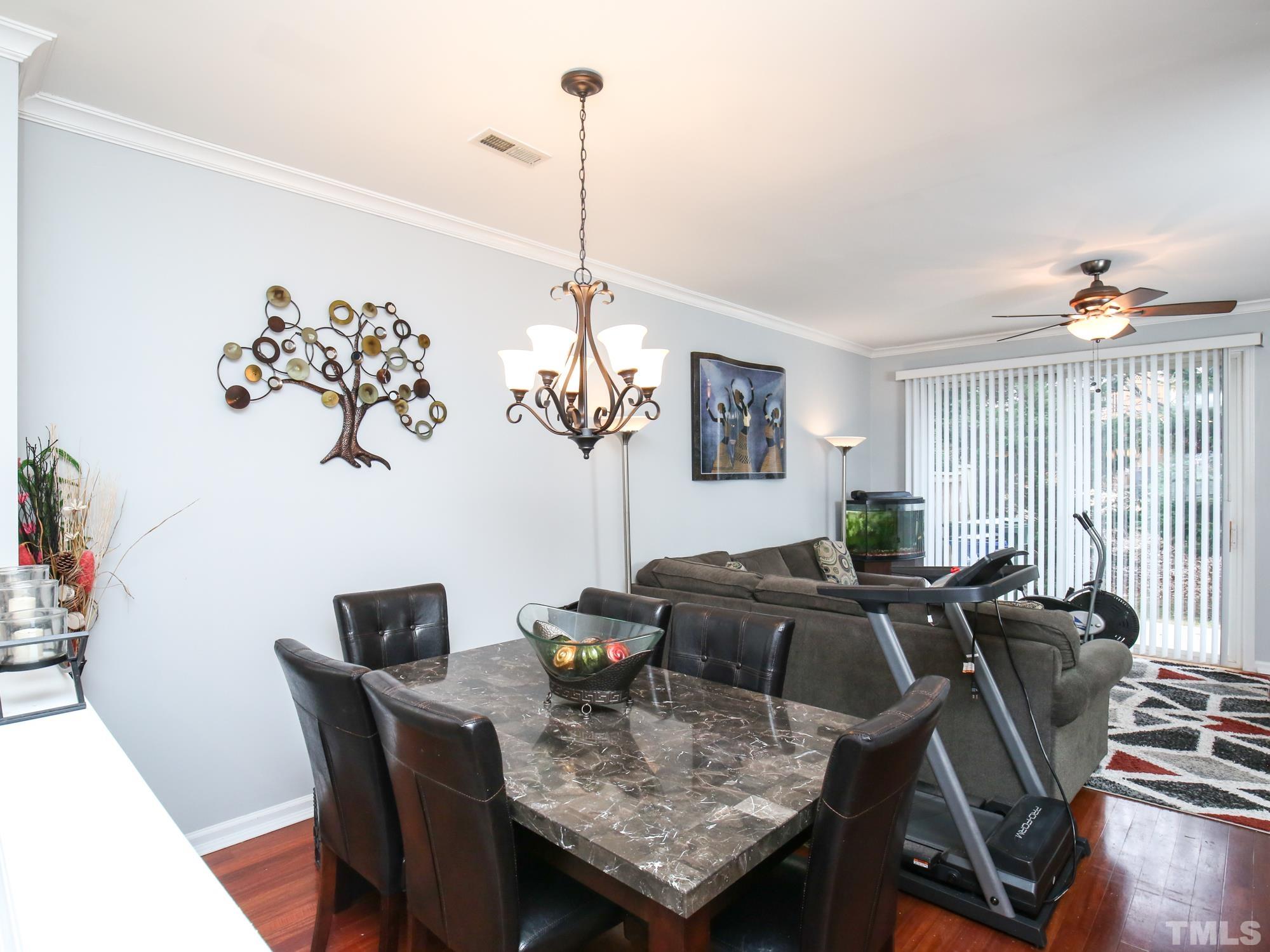 1714 Sorrell Brook Way Raleigh, NC 27609 - Photo 8 of 29 a view of a dining room with furniture window and wooden floor