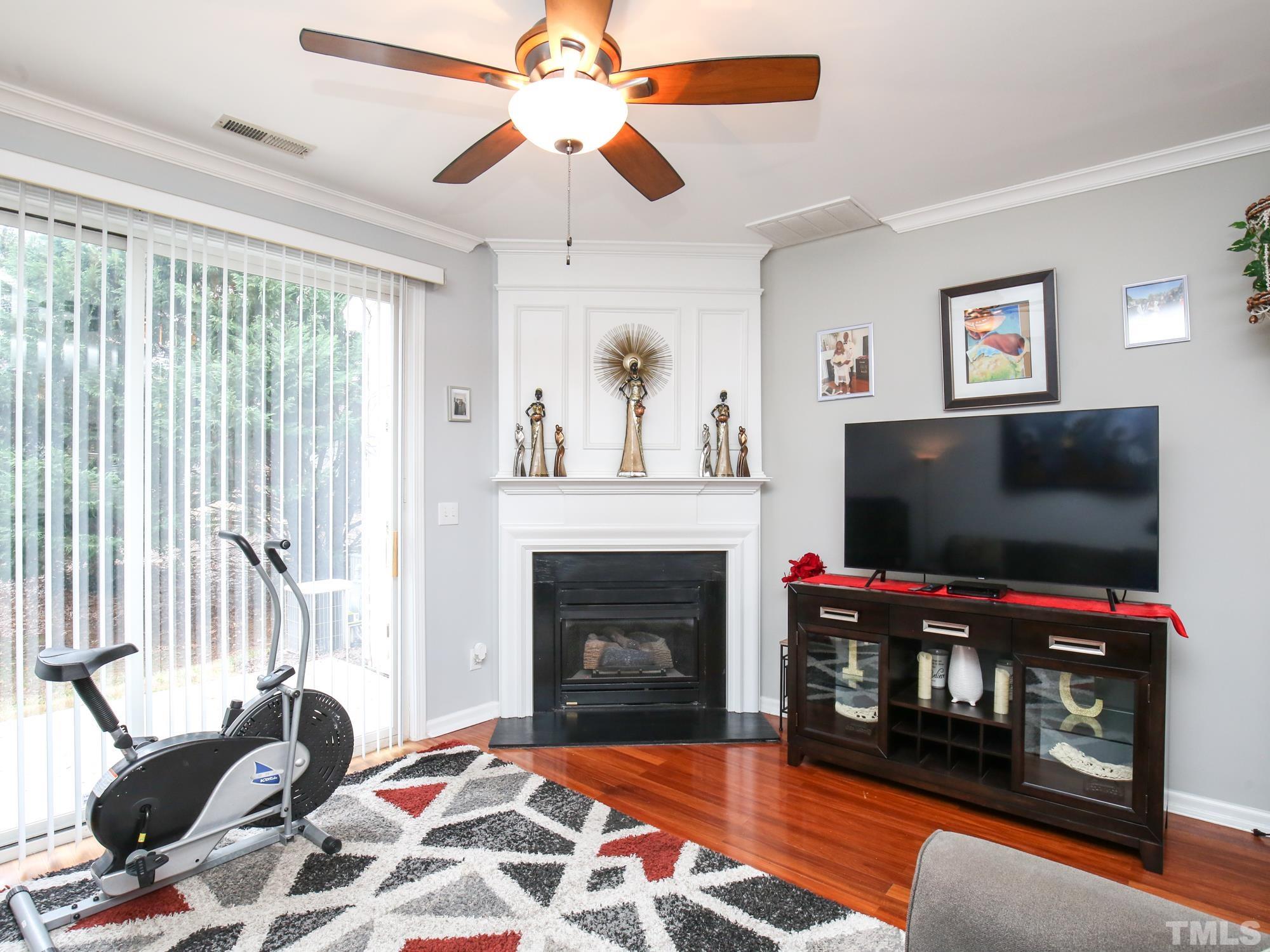 1714 Sorrell Brook Way Raleigh, NC 27609 - Photo 10 of 29 a living room with furniture a flat screen tv and a fireplace
