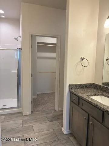 a bathroom with a glass shower door