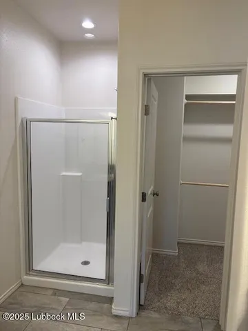 a bathroom with a granite countertop toilet sink and mirror