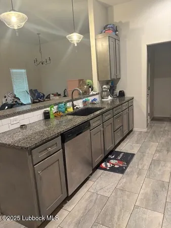 a kitchen with granite countertop a refrigerator and a stove