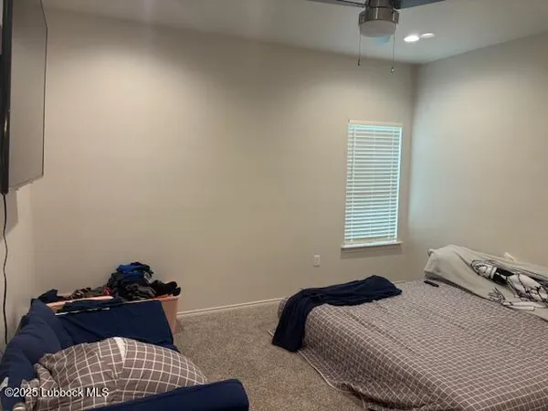 a view of a hallway with closet and a window